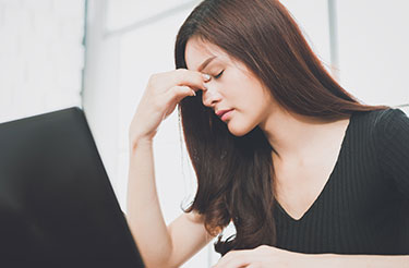 Woman experiencing post-concussion headache and fatigue