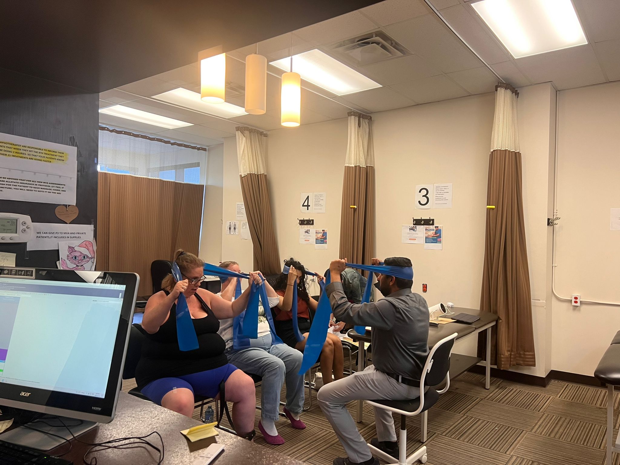 Workshop - main - 1 Patients performing shoulder rehab exercises at Caring Hands Physiotherapy Calgary